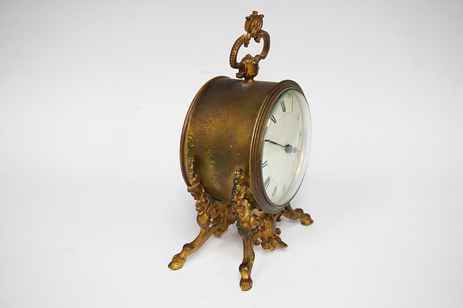 A French gilt metal mantel clock with enamelled Roman numeral dial and drum movement, 18.5cm high. Condition - fair, untested